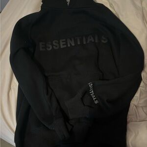 Small black essentials hoodie that fits like a size medium